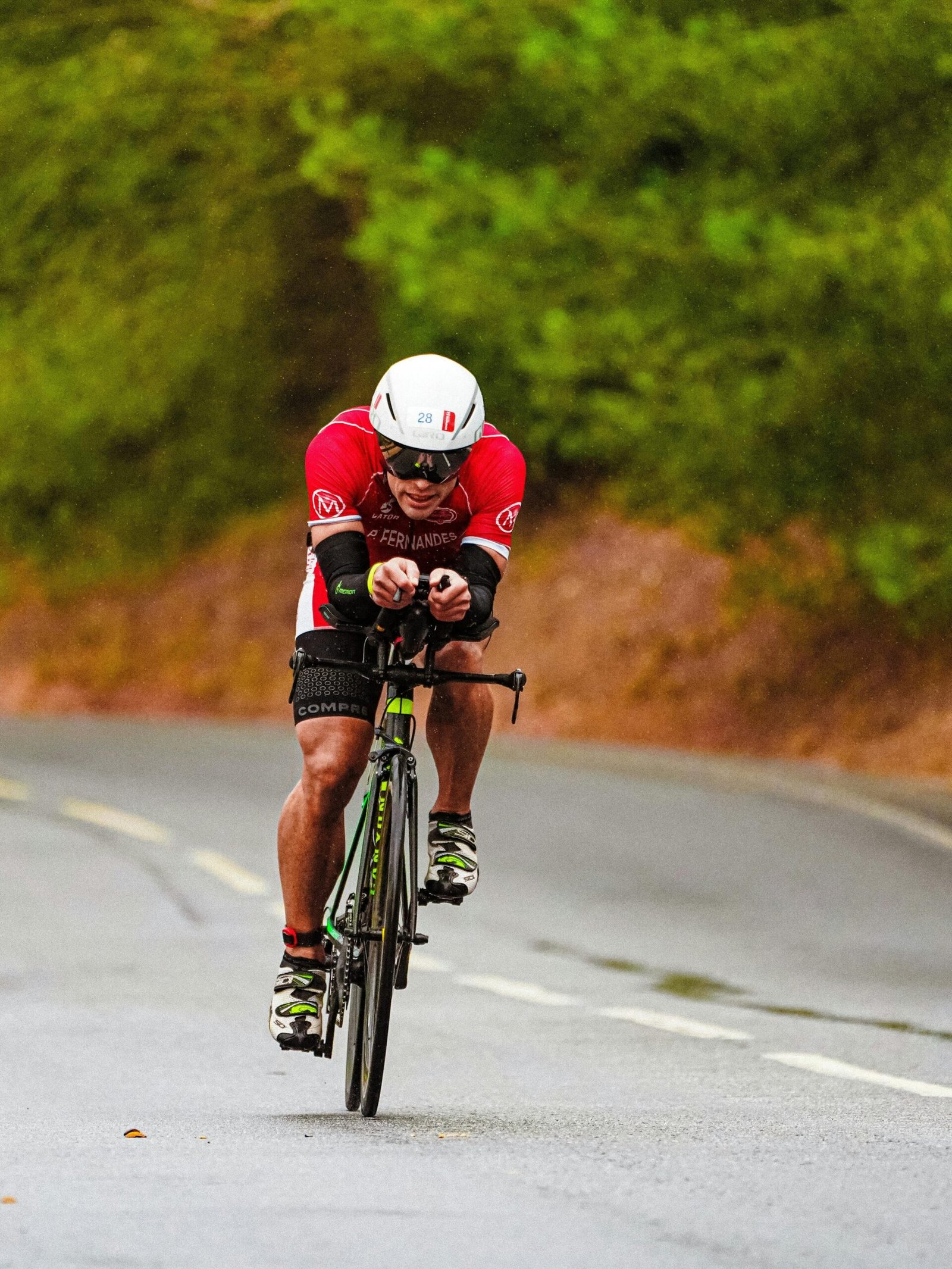 img-01-free-img Full body of focused young slender bicyclists in sportswear and helmets holding handlebars while riding bikes on uneven road out of city